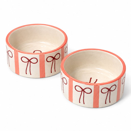 Set of 2 cream ceramic serving bowls with bow and stripe pattern