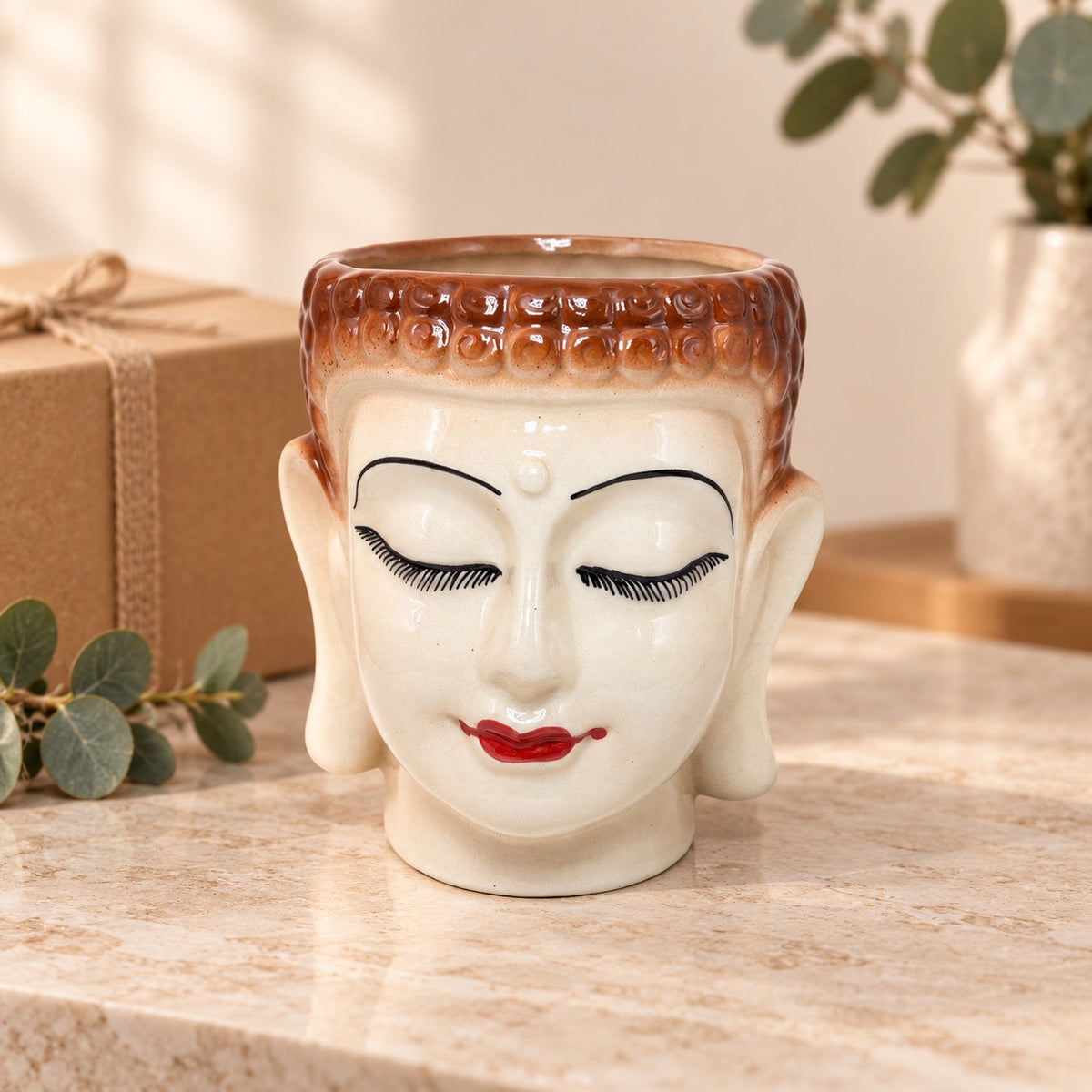 Large Buddha face ceramic planter styled as a decorative home decor gift