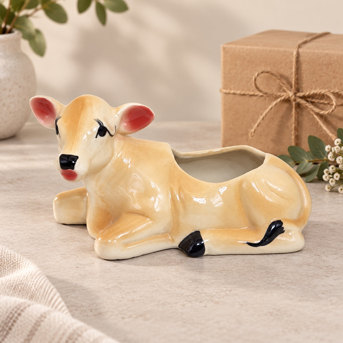 Cow-shaped ceramic planter styled as a decorative gift item