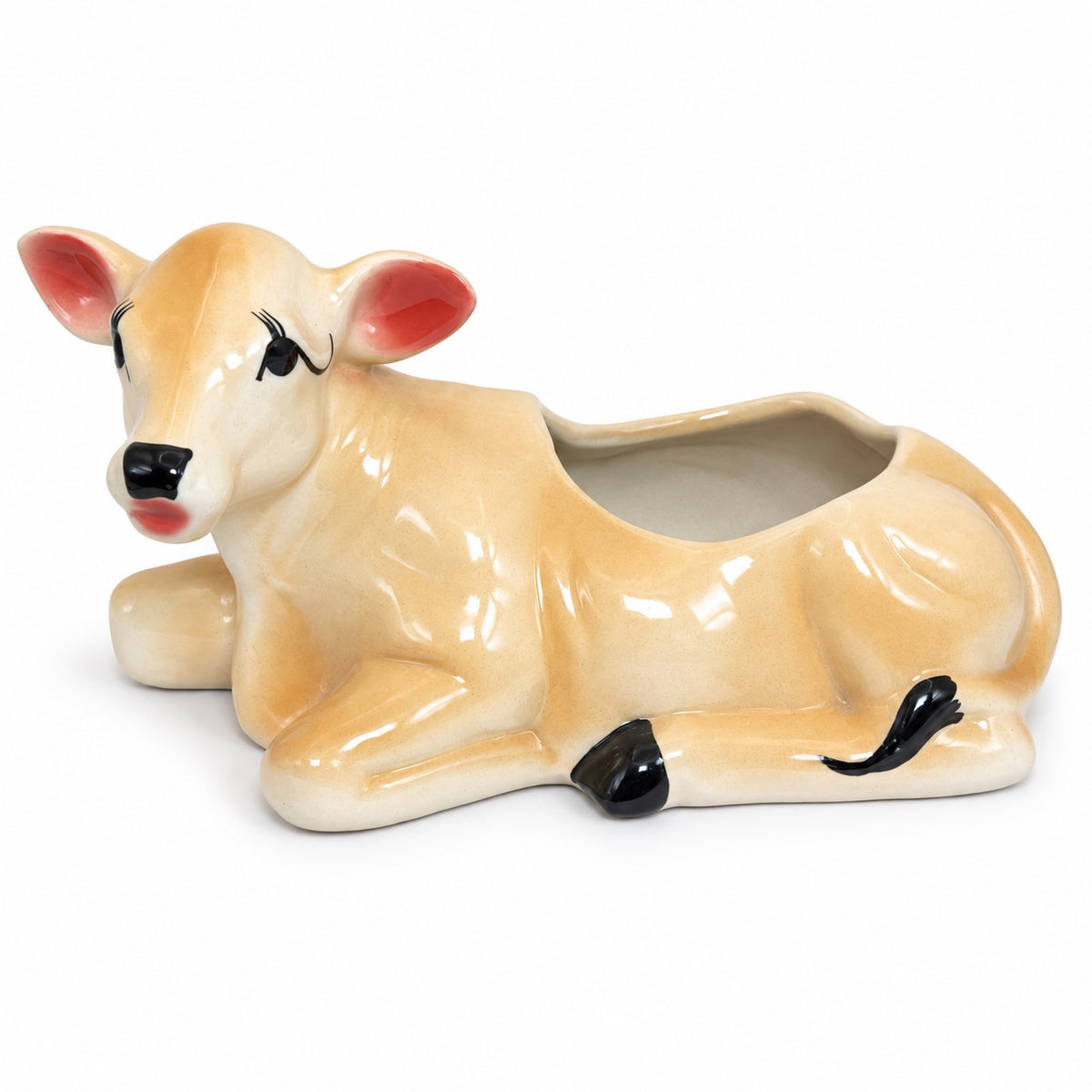 Glossy ceramic cow-shaped indoor planter on white background