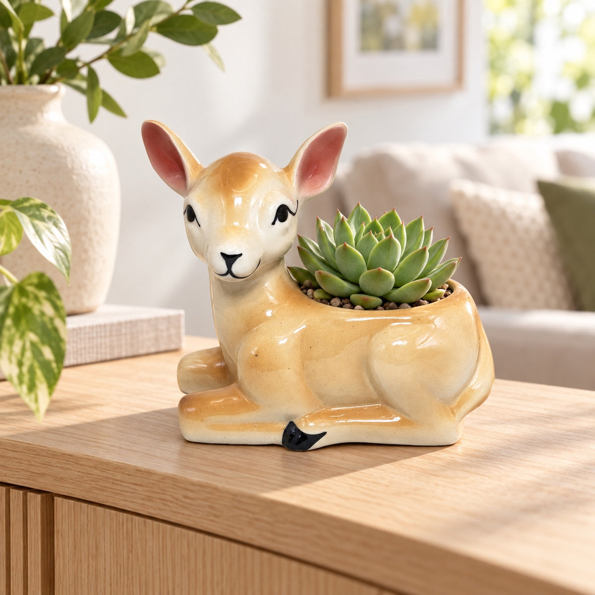 Deer shaped ceramic indoor planter styled with a succulent on a wooden table