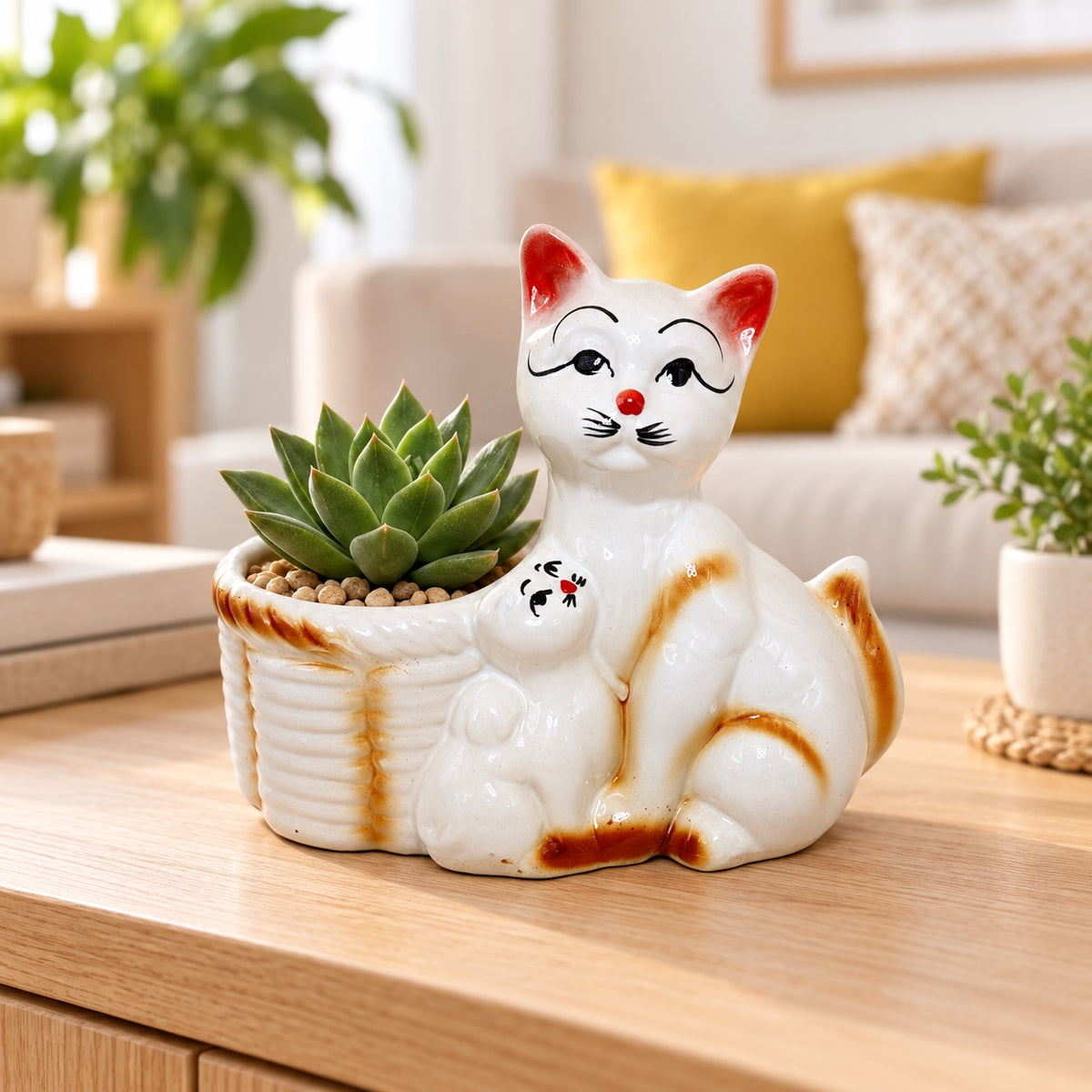 Mother cat and kitten ceramic indoor planter styled with a succulent on a wooden table